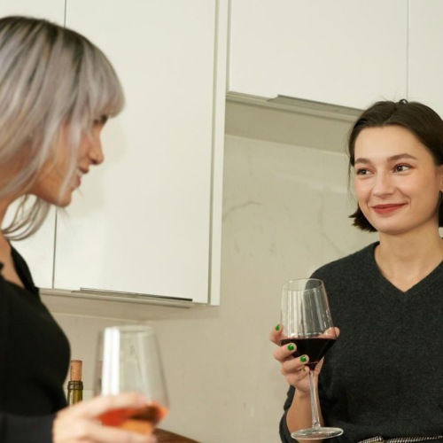 a couple of women holding wine glasses
